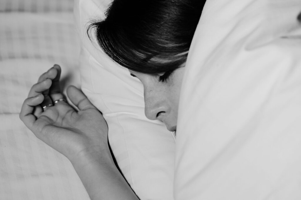 Close-up of a person sleeping peacefully, captured in monochrome for a serene feel.