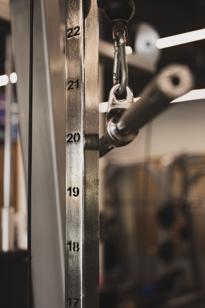 Close-up shot of a gym equipment weight stack in a fitness center.