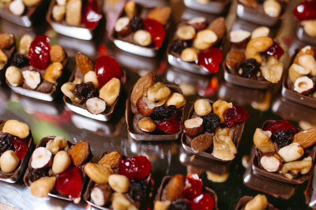 Delicious chocolate bites filled with assorted nuts and dried fruits on display.