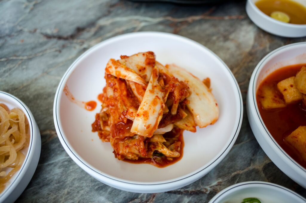 Delicious traditional Korean kimchi served in a white bowl, perfect for Asian cuisine enthusiasts.