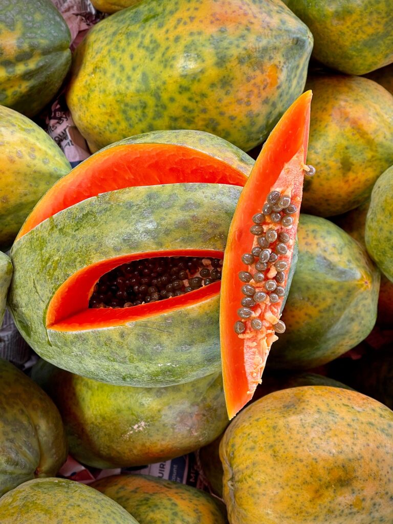 Vibrant ripe papayas on display, showcasing rich orange flesh and seeds.